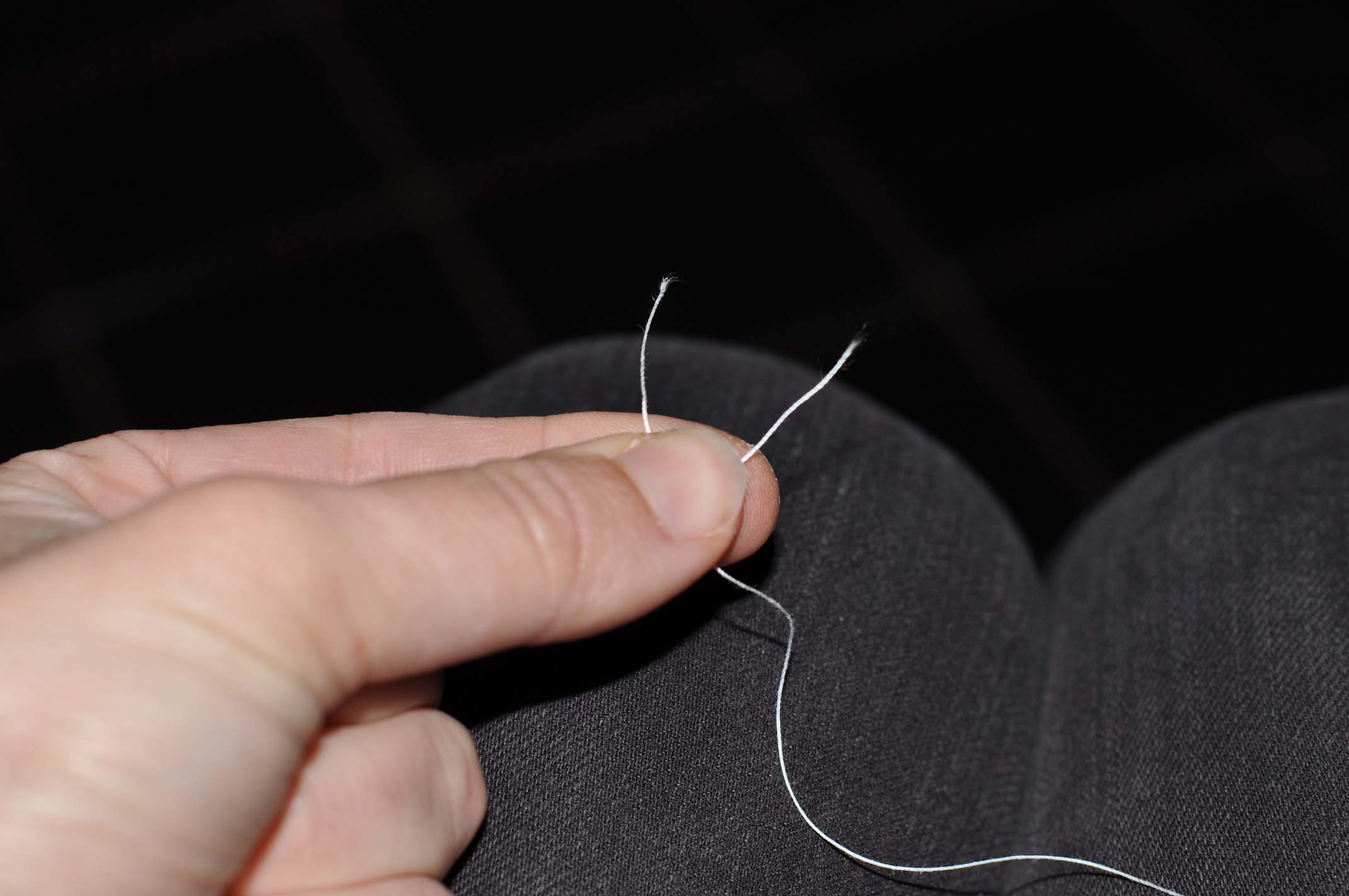 Secure the crossed bobbins threads between the thumb and forefinger of the left hand.